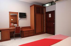 - une chambre avec un bureau et un bureau avec un ordinateur dans l'établissement Super OYO 742 Mona Plaza Hotel, à Pekanbaru