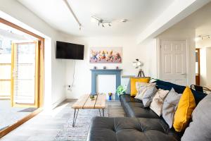 a living room with a couch and a fireplace at The Nook - TV in Every Bedroom! in Swansea