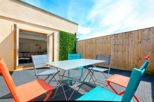 a table and chairs in front of a building at The Nook - TV in Every Bedroom! in Swansea