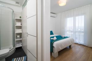 Posteľ alebo postele v izbe v ubytovaní Lotus Apartman