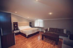 a bedroom with a bed and a couch at Goy Gol Lake Resort in Goygol