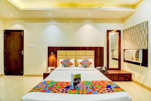 a bedroom with a large bed in a room at FabHotel Solitaire Inn in Kānpur
