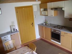 a kitchen with a sink and a stove top oven at Haus Marion in Jerzens