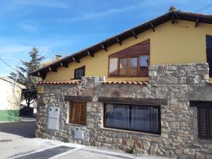 een stenen huis met een raam aan de zijkant bij Casita Morada in Navalespino