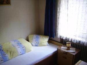 a small bedroom with a bed and a window at Haus Marion in Jerzens