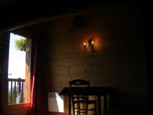 a dining room with a table and a chair and a window at LE MEGEVAN in La Giettaz