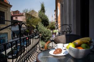 a bowl of fruit on a table on a balcony at Boutique Guest house 7th Sense in Plovdiv