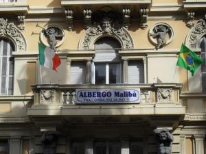 a building with a clock on the front of it at Albergo Malibu in Sanremo