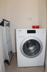 a white washing machine in a corner of a room at Sonnengarten 19 in Kellenhusen