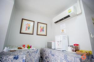 a kitchen with two tables with blue and white tiles at Pho Place in Bangkok