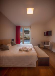 a hotel room with a bed and a desk at La Villa - Luxury Guest House in Trento