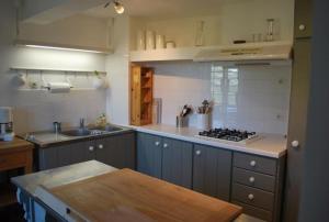 a kitchen with a sink and a stove in it at Mas 20 personnes en Drôme provençale, région de Nyons in Chaudebonne