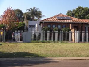a white fence in front of a house at 273 Rhino retreat-solar backup in Centurion