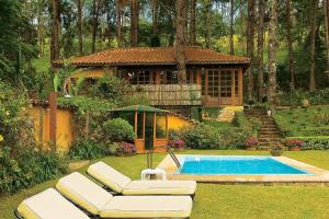 un cortile con piscina e una casa di Hotel Fazenda Santa Marina a Santana dos Montes