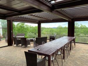 a large wooden table and chairs on a patio at Villa Le Bolli in Radicondoli