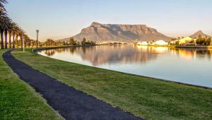 a body of water with a mountain in the background at Milnerton Guesthouse in Cape Town
