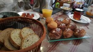 a table topped with baskets of bread and pastries at MARGARIDOU in Blesle