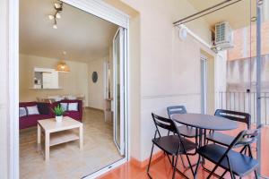 a room with a table and chairs and a living room at Be Barcelona Eixample Urquinaona II in Barcelona