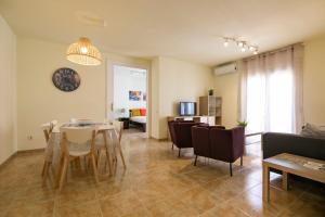 a living room with a dining room table and chairs at Be Barcelona Eixample Urquinaona II in Barcelona
