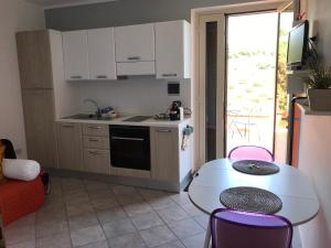 a kitchen with a table and a sink and a table and chairs at Terramare in Castel di Tusa