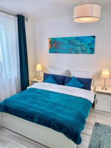 1 dormitorio con 1 cama con manta azul en Im kleinen Stil l, en Linz am Rhein