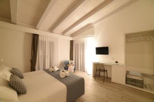 a bedroom with a bed with two stuffed animals on it at La Torre del Mulino - SUPERIOR Rooms in Tropea