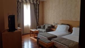 Posteľ alebo postele v izbe v ubytovaní Riviera Hotel