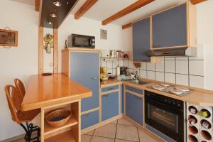 a small kitchen with blue cabinets and a counter at Ferien- und Messewohnung/ Apartment in Wahlscheid