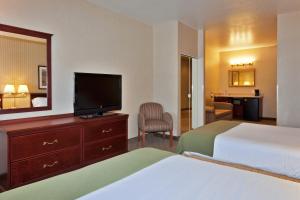 a hotel room with two beds and a flat screen tv at Holiday Inn Express Hotel and Suites - Henderson, an IHG Hotel in Las Vegas