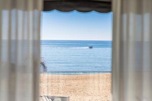 a view of the ocean from a window of a beach at Dom Jose Beach Hotel (Plus) in Quarteira
