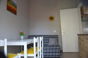 a kitchen with a table and a chair and a table and a table at Daisy Apartment in Asprovalta