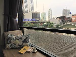 a window with a view of a city skyline at Yaksa Private in Bangkok