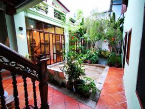 a house with a balcony with potted plants at East Indies Mansion in George Town