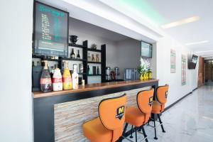 a bar with orange bar stools in a restaurant at OYO 195 Ranchotel - Biñan in Biñan