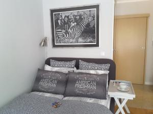 a bedroom with a bed and a picture of a zebra at Atelier Aleksandry in Gdynia