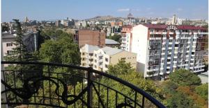 a view of a city from a balcony at Bachos Apartment in Tbilisi City