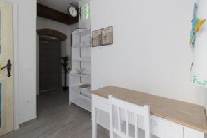 a kitchen with a table and white cabinets at Casato Bapo camera panoramica Aurora in Riomaggiore