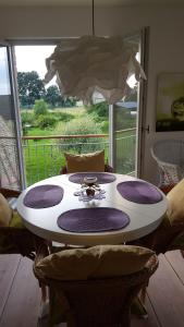 a table in a room with a large window at Landhaus Sinneswandel in Nauen