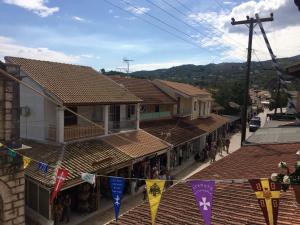 a street in a town with flags and buildings at Helena's Rooms in Kassiopi
