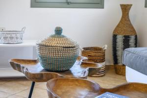 a group of vases sitting on a table in a living room at Mirabeli Apartments & Suites in Pollonia