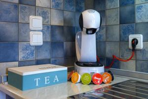 a juicer sitting on top of a counter next to a counter top at Mirabeli Apartments & Suites in Pollonia