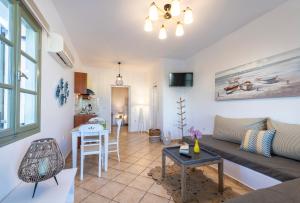 a living room with a couch and a table at Mirabeli Apartments & Suites in Pollonia