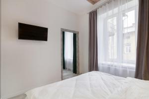Posteľ alebo postele v izbe v ubytovaní LEOGRAND LOFT Apartments on Lychakivska 4