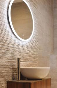 uma casa de banho com um lavatório e um espelho na parede em Golflinks Hotel em Portrush