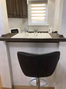 a black stool sitting at a kitchen counter with glasses at Red Stone in Truskavets