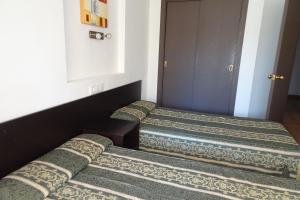 Cama o camas de una habitación en Evamar Apartments