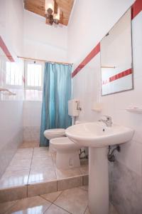 a bathroom with a sink and a toilet at Solemare Residence in Donnalucata