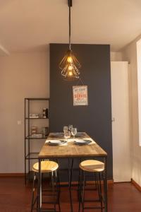 a dining room table with a lamp on top of it at Maloc Agen Centre in Agen