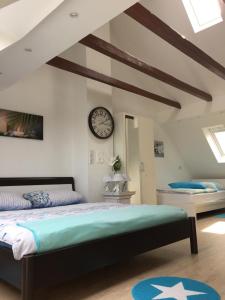 a bedroom with a bed and a clock on the wall at LORENZ Apartment 2 in Hattingen