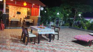 a table and chairs on a brick patio at Royal stay kanchipuram in Kanchipuram